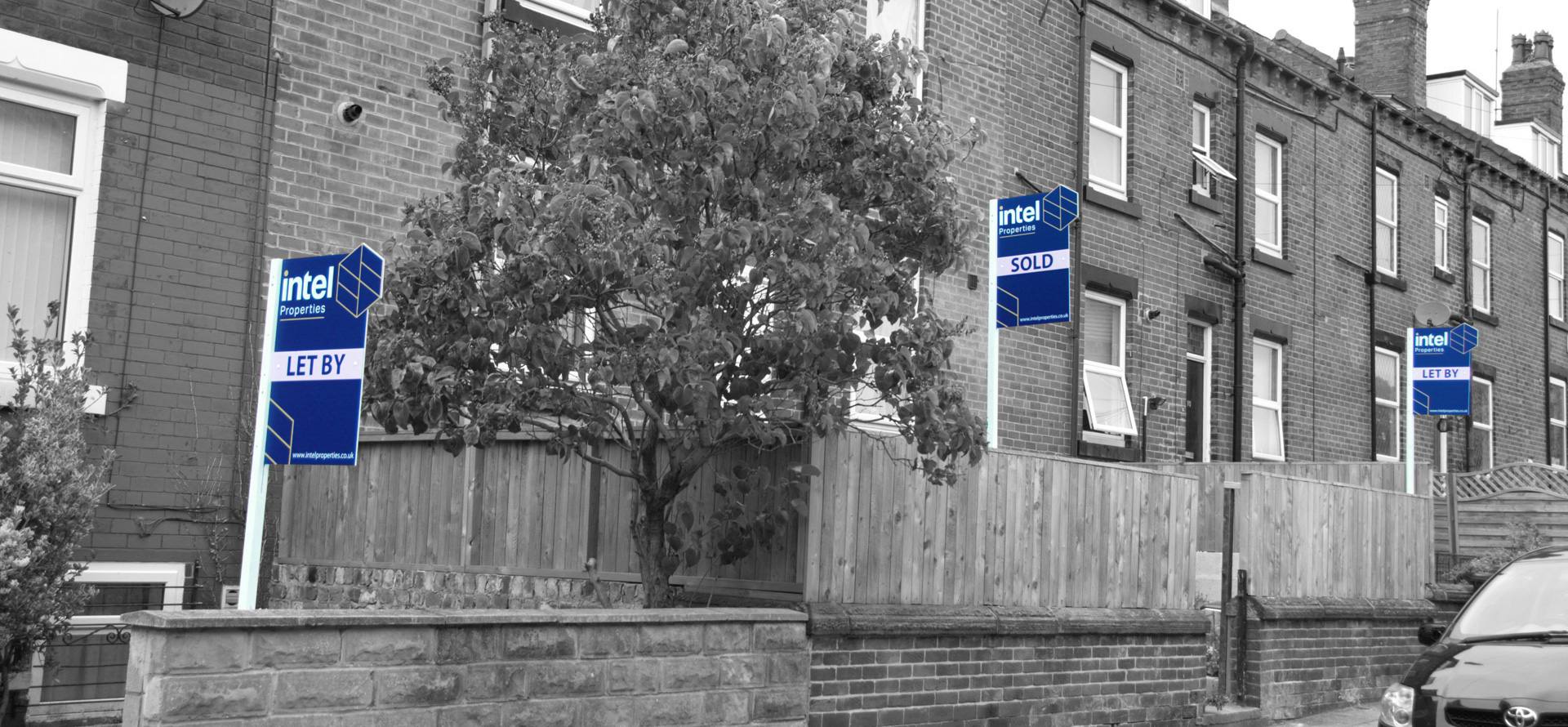 Row of houses with Lintel Properties boards